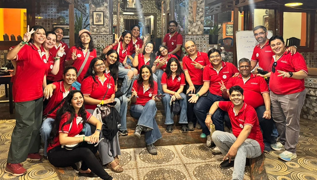 A group of office teammates smiling at the camera.